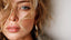 Woman wearing gold hoop earrings