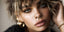woman with gold chunky hoop earrings, septum nose ring, nose piercing and cz stud nose piercing
