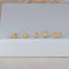 Gold labret flat back stud earrings in unique shapes, including bee, snake, scorpion, dragonfly, and spider designs — perfect for curated ear styling.