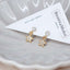 Petite gold star earrings with dangling rhinestone charms and crystal studs, perfect for girls’ jewelry, dainty looks, or sparkle lovers.